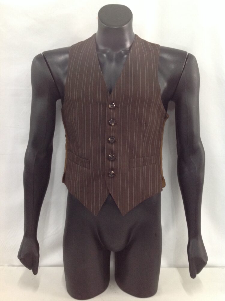 Men's waistcoat for hire. This men's vest has 3 buttons on the front with a blue striped self pattern. Add a hippy shirt for a great 60's look or wear this vest with any gangster suit, dress up a regular suit and add a cravat for a Titanic look. Also perfect with a cap and braces for a Peaky Blinders look. 